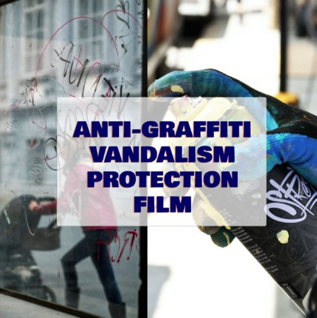 Person applying anti-graffiti vandalism protection film on a glass surface.