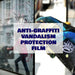 Person applying anti-graffiti vandalism protection film on a glass surface.