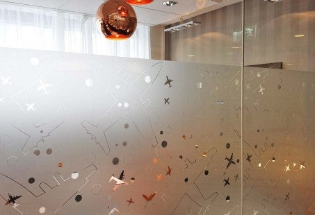 Decorative glass wall with abstract patterns in an indoor setting