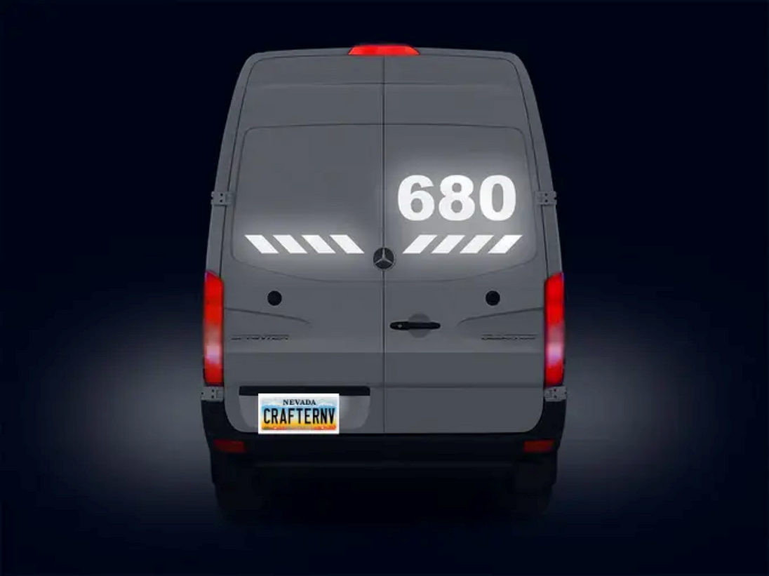 Back view of a van with '680' displayed on the rear window against a dark background