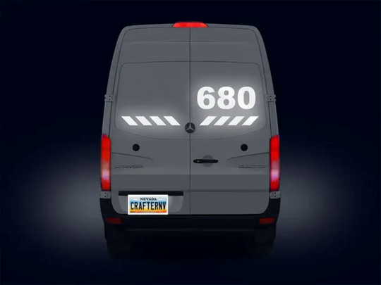 Back view of a van with '680' displayed on the rear window against a dark background