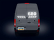 Back view of a van with '680' displayed on the rear window against a dark background