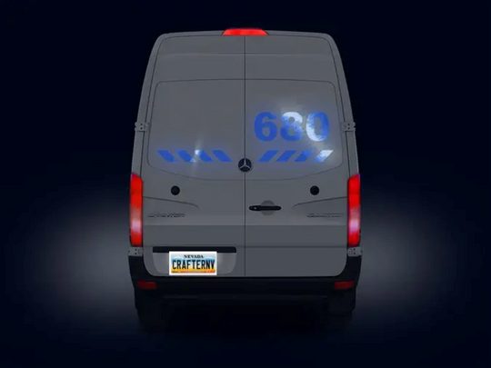 Back view of a Mercedes-Benz van with illuminated number '630' on a dark background