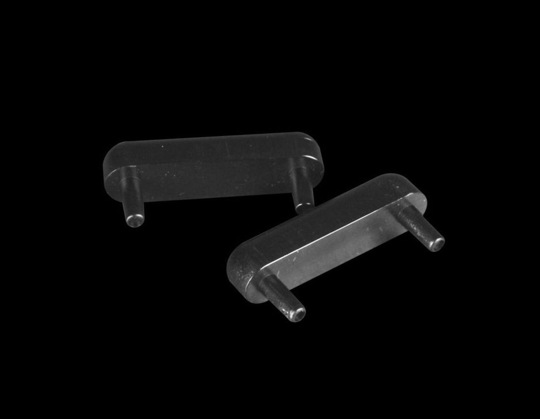 Two metallic brackets on a black background