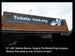 Large outdoor banner on a building with text and a website URL.