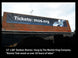 Large outdoor banner on a building with text and a website URL.