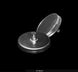 Metallic circular object with a central screw on a black background