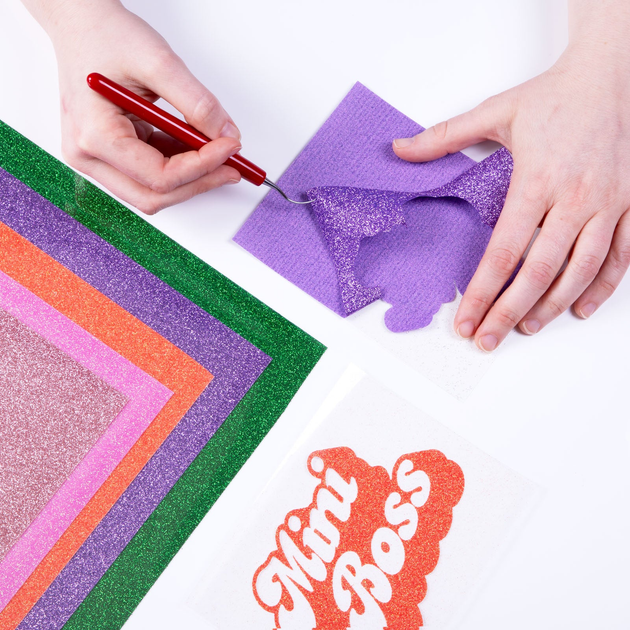 Weeding a cut design from Siser Glitter heat transfer vinyl; application example