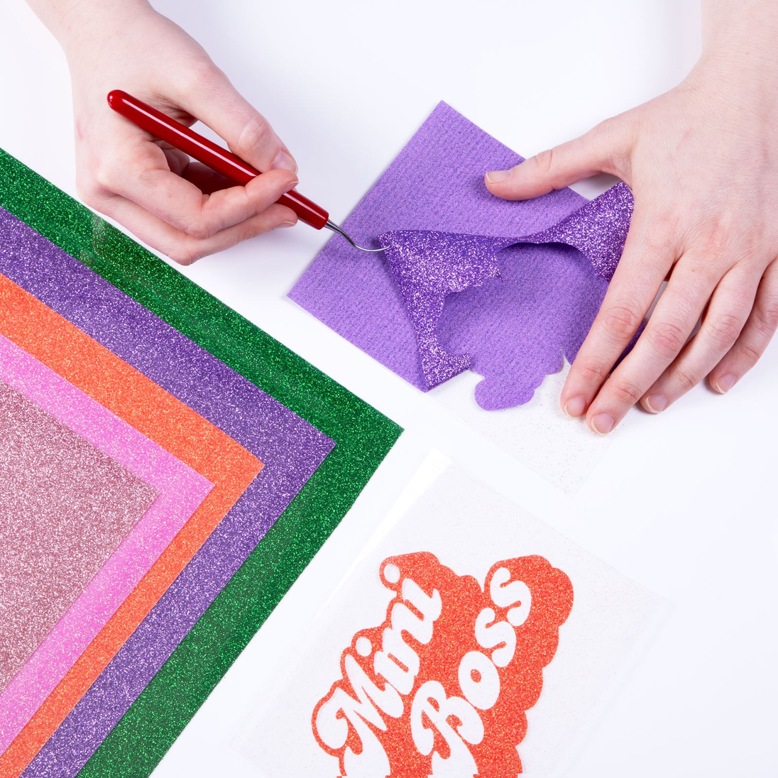 Weeding a cut design from Siser Glitter heat transfer vinyl; application example