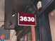 Red sign with '3630' on a building exterior