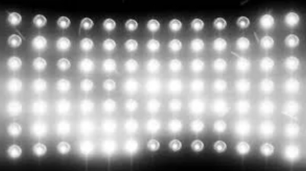 Grid of bright white lights on a black background