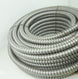 Coiled metal hose on a white background