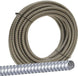 Coiled metal flexible conduit on a white background