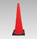 Red traffic cone with black base on a gray background