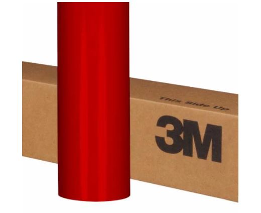 Red roll of 3M vinyl wrap against a cardboard box