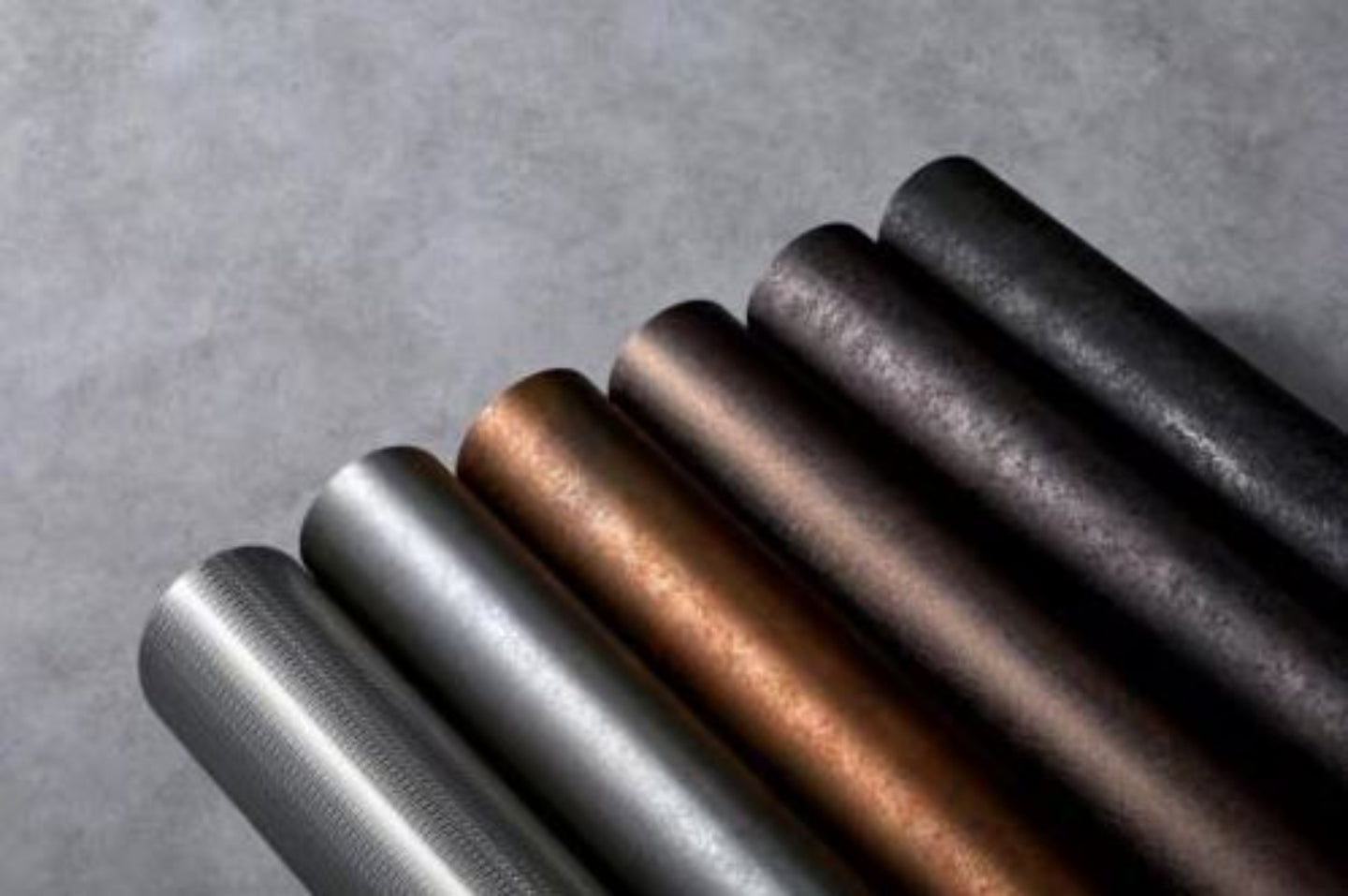 Metallic ribbons in various colors on a textured gray background