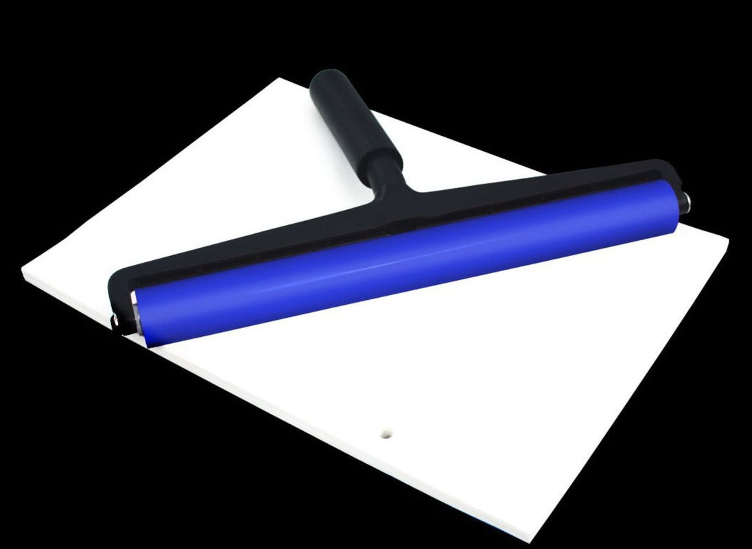 Blue squeegee on a white surface with a black background