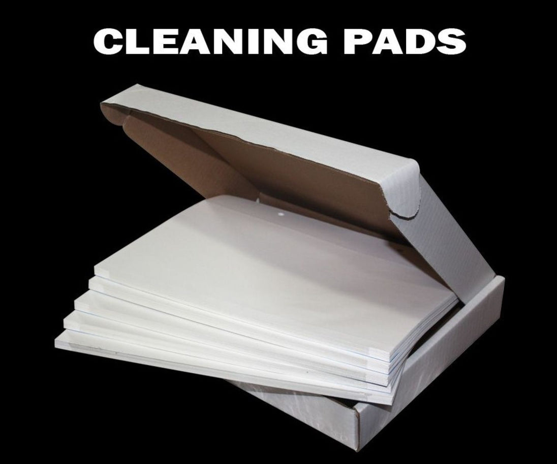Box of cleaning pads with 'CLEANING PADS' text on a black background