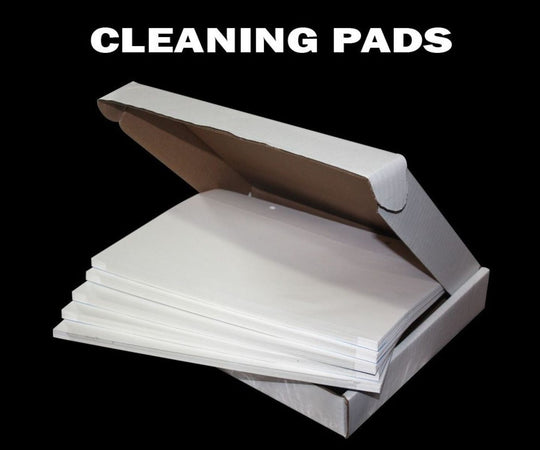 Box of cleaning pads with 'CLEANING PADS' text on a black background