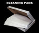 Box of cleaning pads with 'CLEANING PADS' text on a black background