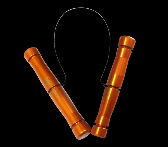 Metallic jump rope with orange handles on a black background