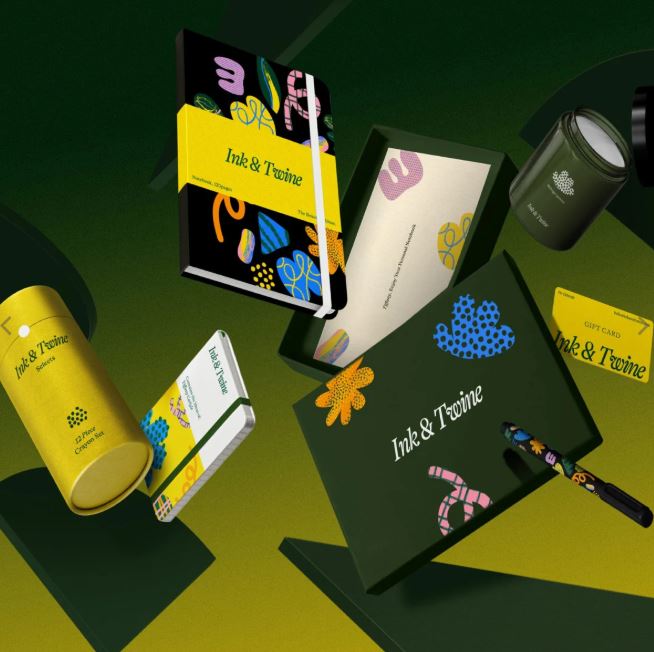 Collection of 'Ink & Twine' stationery items on a green background
