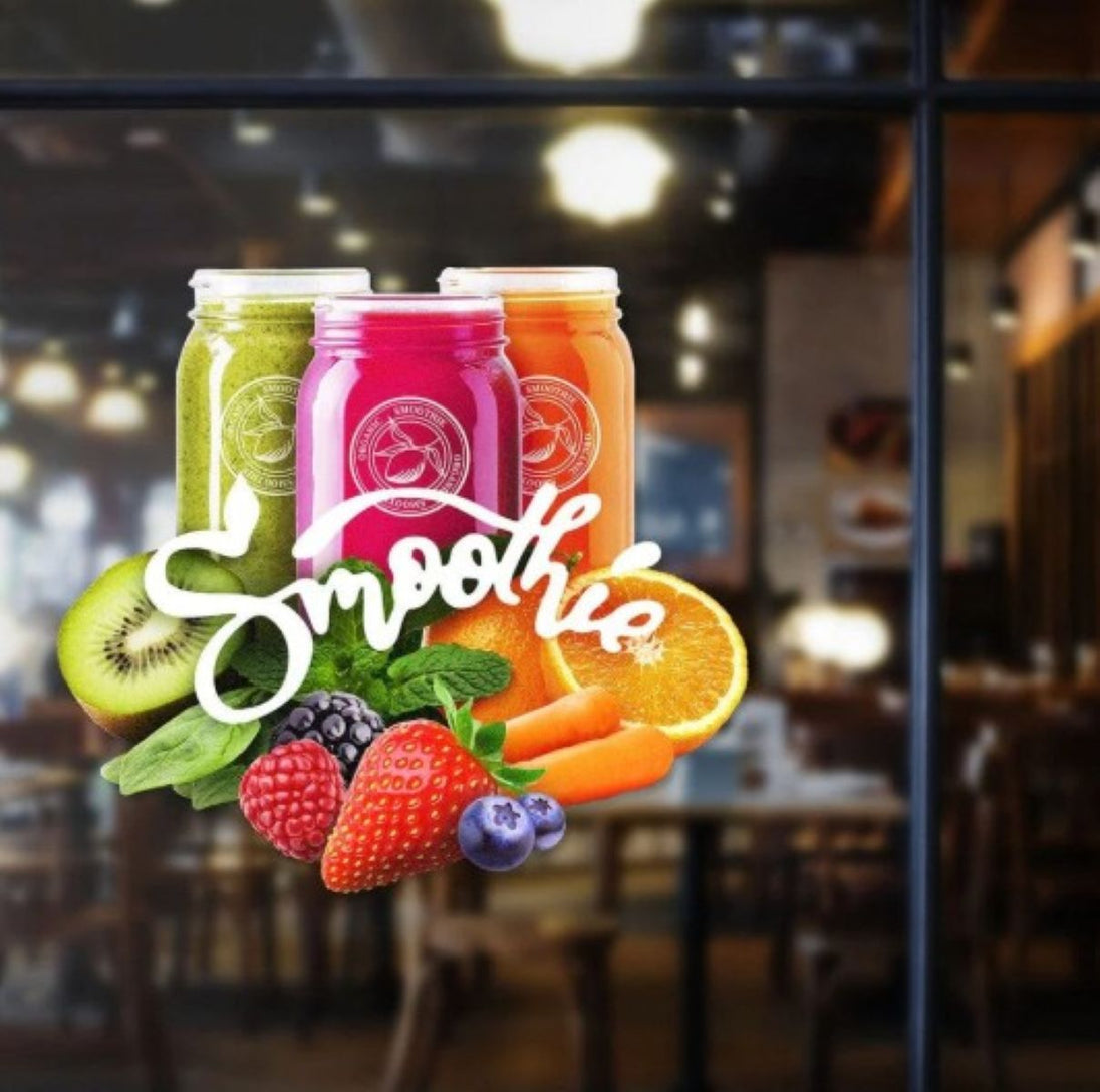 Three colorful smoothie jars with fruits and a blurred restaurant interior.