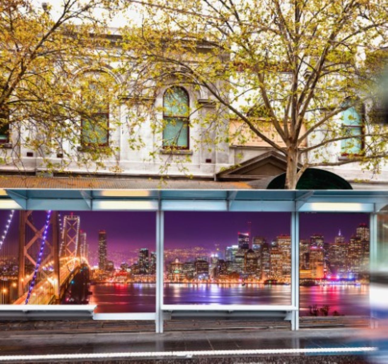 Bus stop with cityscape and tree reflections