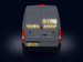 Back view of a gray van with illuminated number '5100' on a dark background
