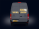 Back view of a gray van with illuminated number '5100' on a dark background