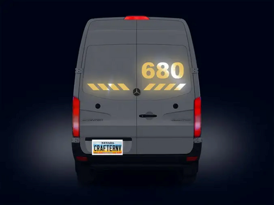 Back view of a gray van with digital display and 'Crafterny' branding on a dark background