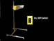 Yellow on/off switch attached to a metal stand with a black background