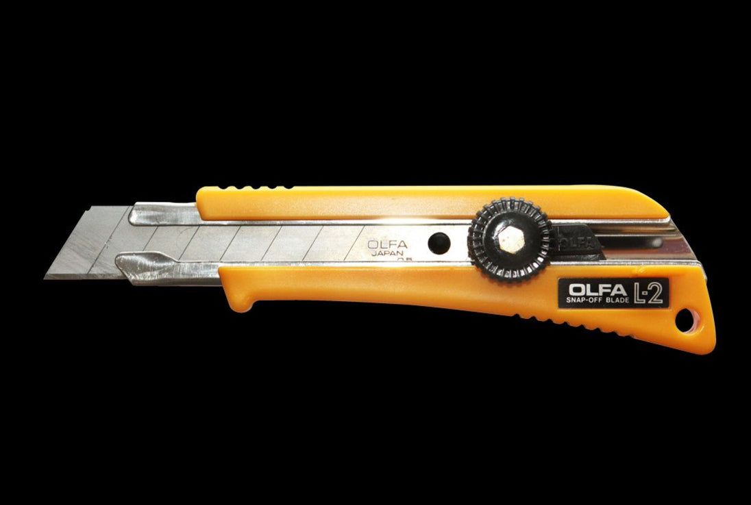 Olfa cutter knife with orange handle on a black background