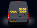 Back view of a gray van with yellow numbering and brake lights on a black background