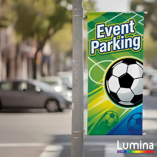 Colorful 'Event Parking' banner with soccer ball design on a street pole, featuring the Lumina brand.