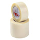Two rolls of clear tape stacked on a white background, with the top roll showing a red and white brand label.