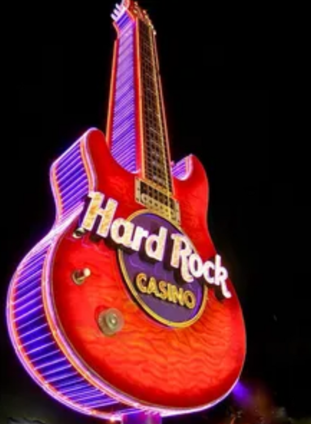Red electric guitar-shaped neon sign with 'Hard Rock Casino' branding on a dark background