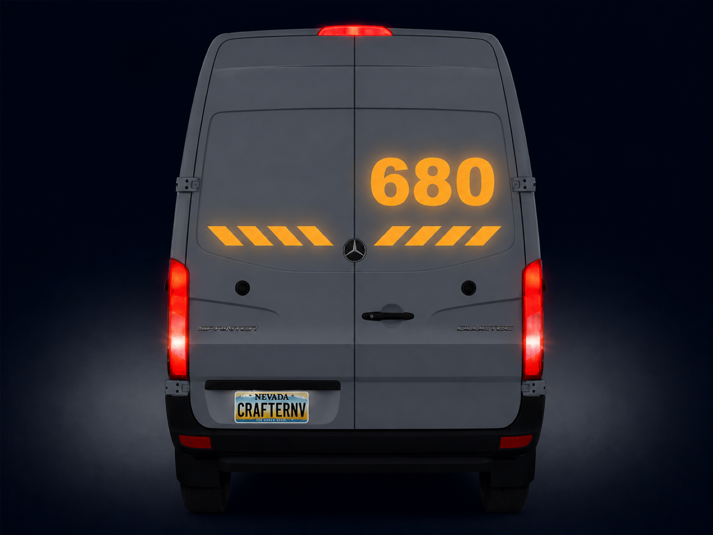Back view of a van with large '680' displayed on the door against a dark background