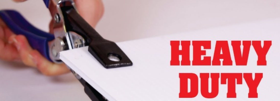 Hand using a heavy-duty paper cutter with 'HEAVY DUTY' text displayed.