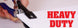 Hand using a heavy-duty paper cutter with 'HEAVY DUTY' text displayed.