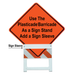 Orange construction sign with text and a plastic barricade stand on a white background