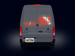 Back view of a van with digital display and red lights on a dark background