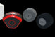 Red and black tool with two gray wheels on a black background