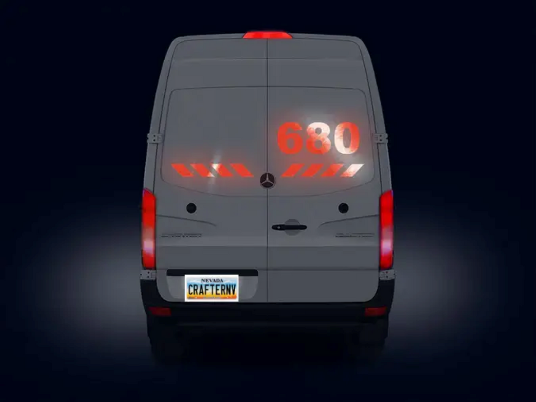 Back view of a Mercedes-Benz van with digital display on a dark background