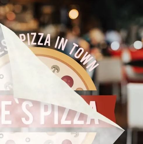 Blurred image of a pizza with 'Pizza in Town' text overlay