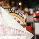 Blurred image of a pizza with 'Pizza in Town' text overlay