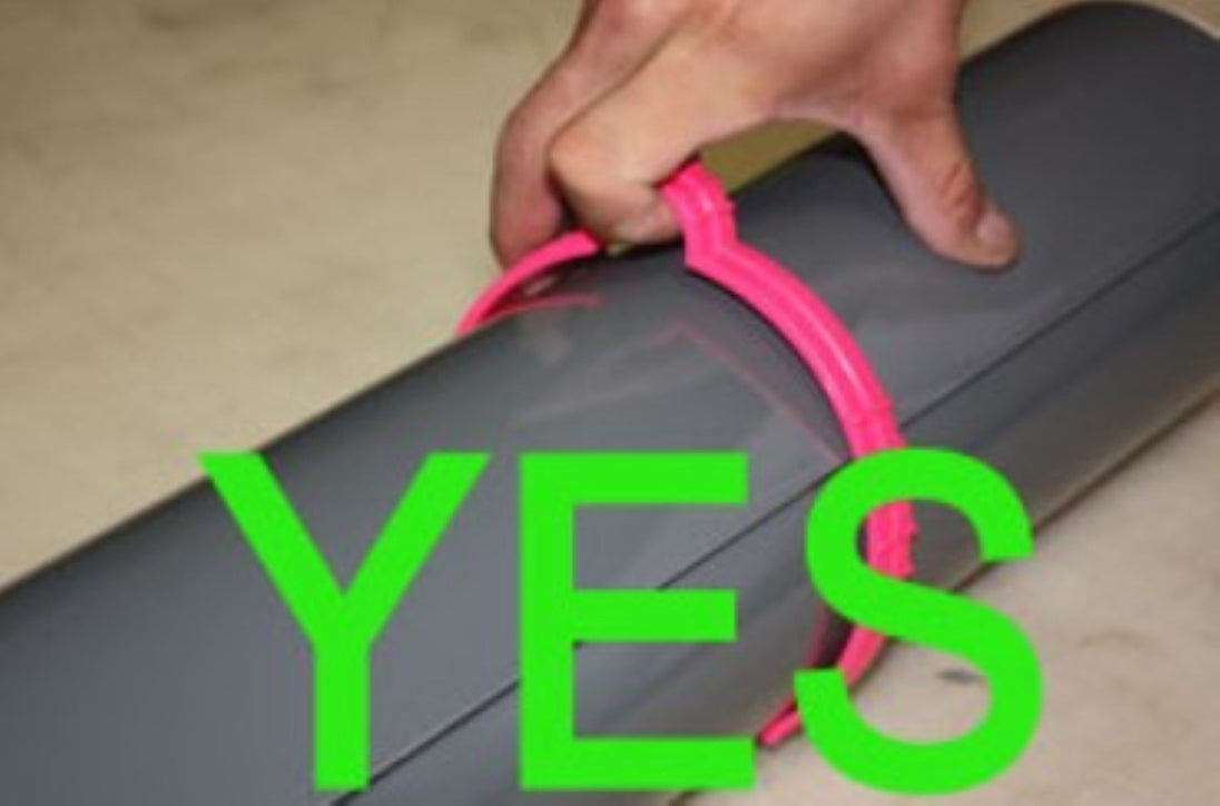 Hand holding a pink object with the word 'YES' in green text overlay on a neutral background