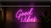 Illustrative pink Good Vibes neon wall sign in an indoor lounge; application illustration for Allanson SS1235ICH indoor neon power supply