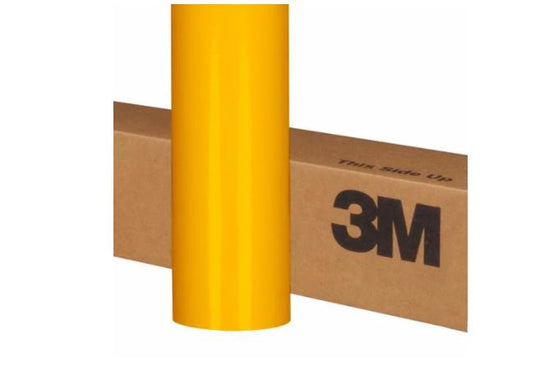 Roll of yellow 3M vinyl wrap on a cardboard box with 'This Side Up' text.