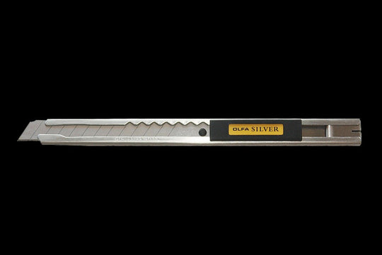 Utility knife with 'Olfa Silver' branding on a black background